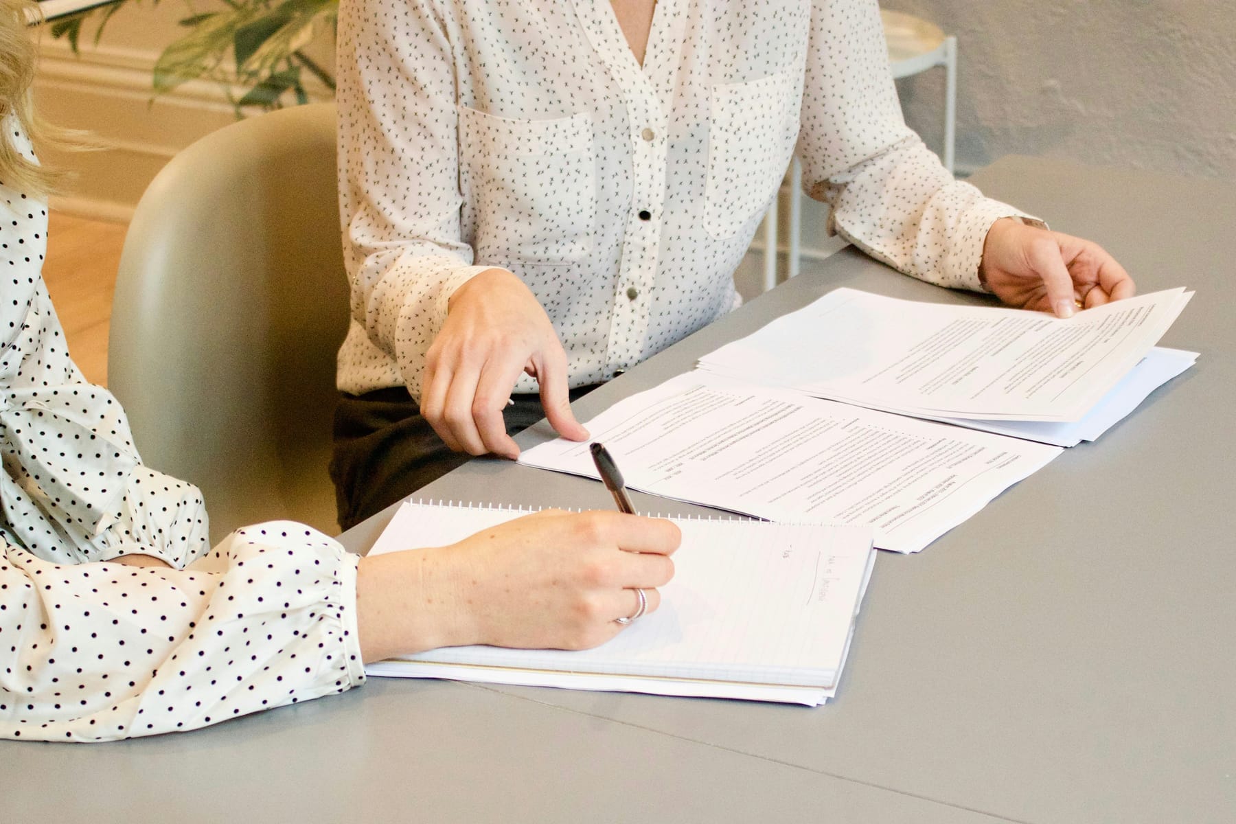 Two people reviewing documents together in an office